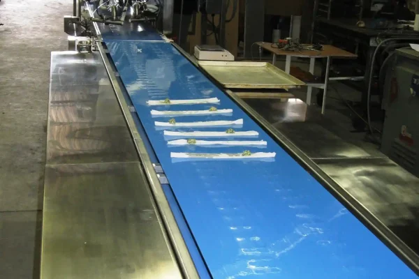 Anti-microbial flat belt food conveyor with stainless steel side tables