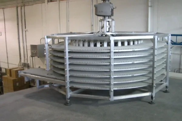 Spiral cooling conveyor for pastries installed on mezzanine