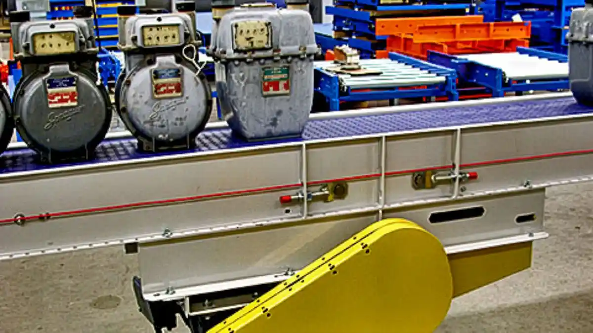 Packaging conveyor system with belt-driven roller sections moving boxes and bags through labeling and palletizing