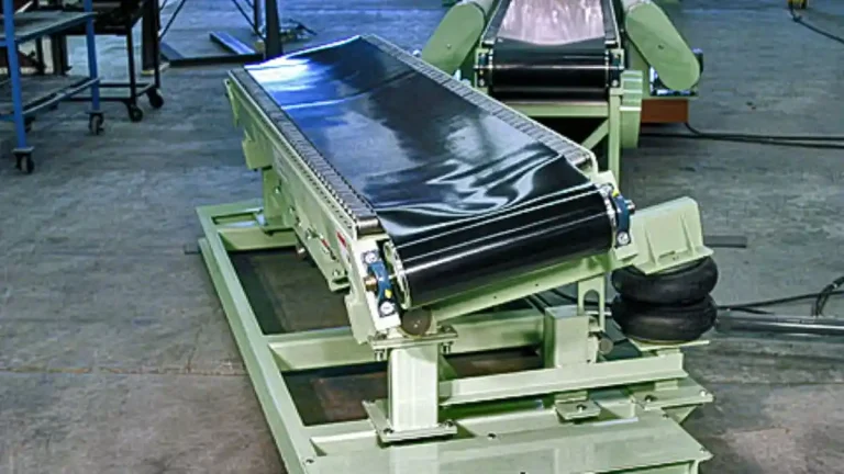 Paper roll handling conveyor system with cradle supports and integrated weighing and wrapping stations