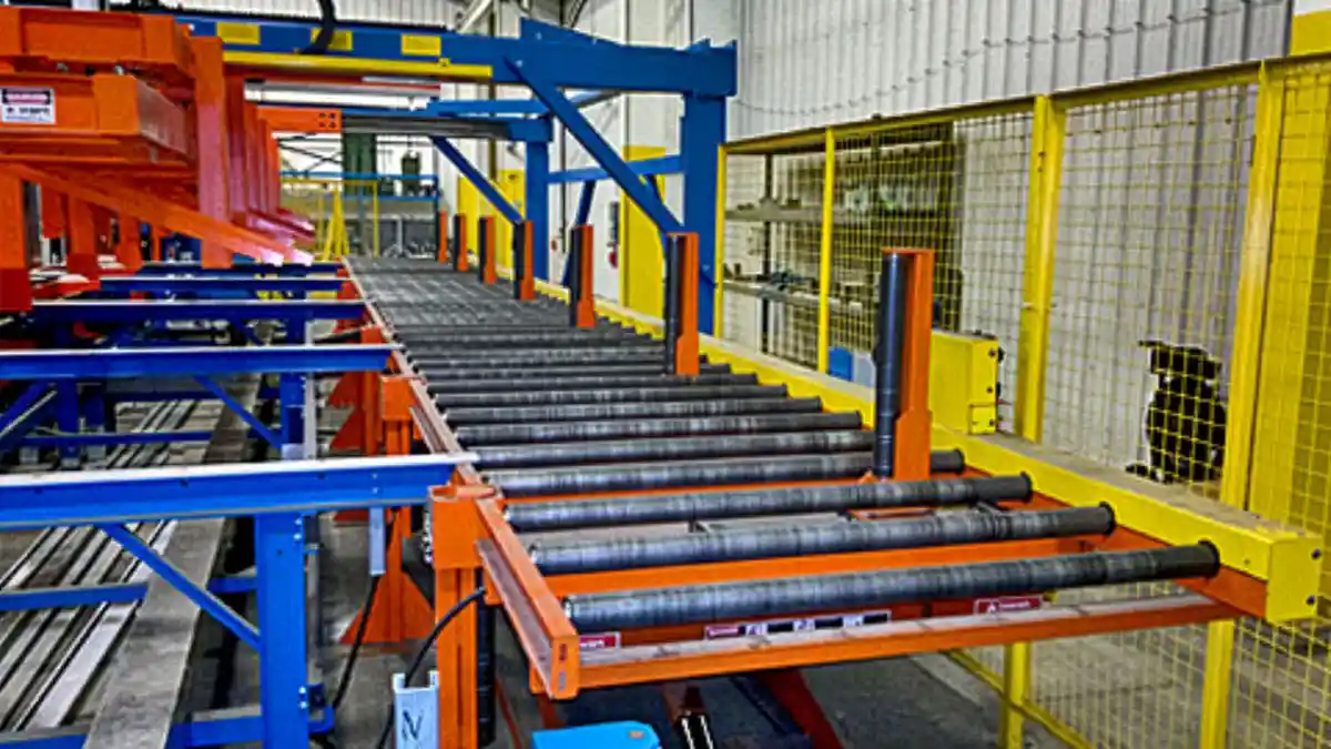 Run-out conveyor system with base-rail transfers and kickers guiding roll formed profiles to stacking stations