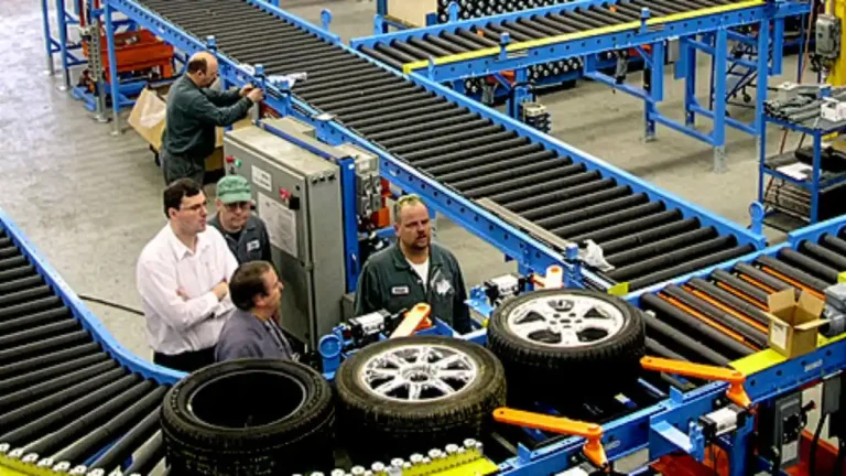 Tire and wheel conveyor system with chain driven live roller sections and accumulation zones for automotive assembly